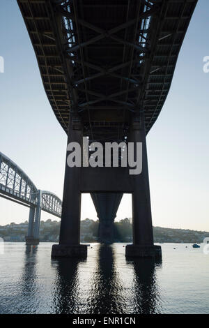 Tamar suspension bridge of 1961 viewed from below, with Brunel's Royal Albert Bridge beside it, at Saltash Passage, Plymouth. Stock Photo