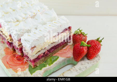 Strawberry cake with whipped cream served on a plate Stock Photo