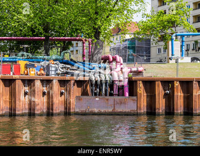 Colourful drainage pipes draining surface water into Spree River from building sites, Berlin Stock Photo