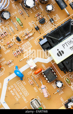 Close up of electronic printer circuit board inside a DVD player. Printed circuits leading to black coated transistors and resistors. Stock Photo