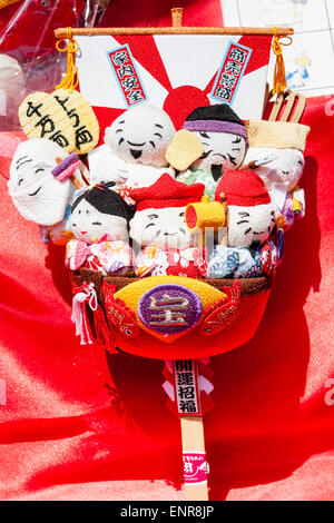 Japan. Japanese cloth shichifukijin, the seven Deities of good fortune in a takarabune, a ship laden with treasure. Often seen at shinto shrines. Stock Photo