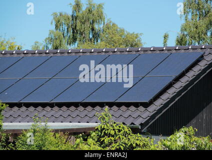 Solar collector on house roof with blue sky Stock Photo