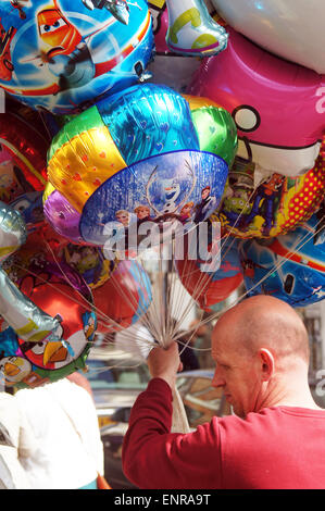 Balloon seller holding colorful balloons Stock Photo