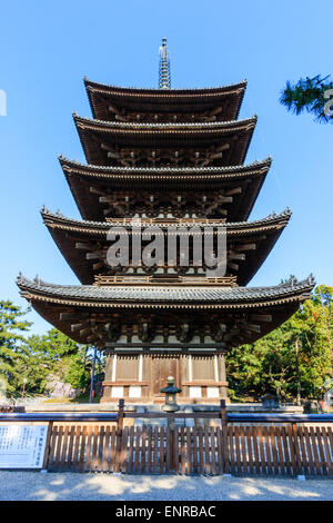 Five storied wooden pagoda at the Kofuku temple in Nara, Japan. Low angle view looking up as it towers against a blue sky. Stock Photo