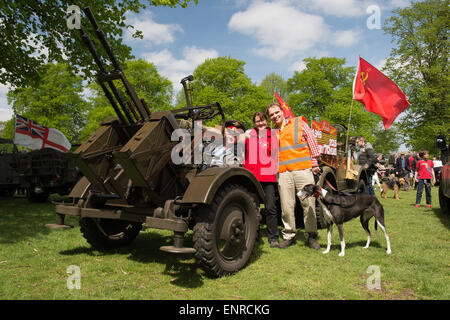 London, UK. 10th May, 2015. On the day after Russia commemorated the end of World War 2, Soviet armour invades Bushy Park in London, part of Chestnut Sunday. Event organiser and Deputy Park Manager Bill Swan with his wife Sarah, Kevin Leigh behind the wheel of Soviet GAZ 69 towing a ZPU anti-aircraft artillery piece. Chestnut Sunday is the biggest day in the park’s calendar. Each year, on the Sunday closest to 11th May, People come from all over London and the South East to join in our local tradition of celebrating the blossom on the magnificent horse chestnut trees in the park. Stock Photo
