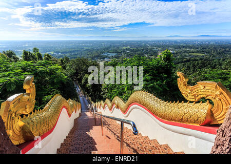 Golden Naka statue on staircase balustrade at Wat Phra That Doi Kham. Temple in Chiang Mai, Thailand Stock Photo