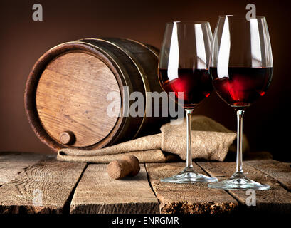Barrel and wineglasses of red wine on a wooden table Stock Photo