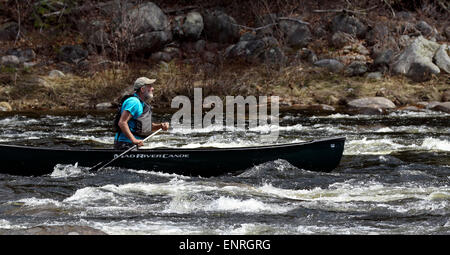 Senior man in a canoe shooting the rapids on the Hudson River New York. Adirondack State Park. Stock Photo