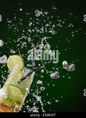 Fresh mojito drink with ice cubes and splashes on black background Stock Photo