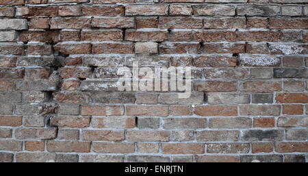 Old red brick wall with a crack Stock Photo