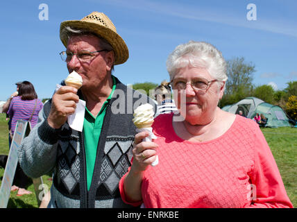 a senior couple enjoying an ice cream at a country fair in cornwall, uk Stock Photo