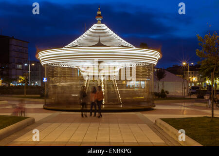 Carousel in motion at night in Castro Urdiales. Cantabria, Spain. Stock Photo