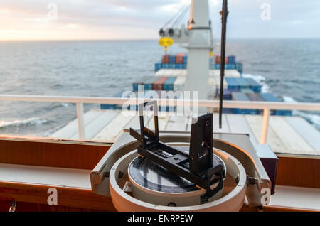 Rotating copmass on the ship bridge of a cargo vessel while sailing in the Atlantic ocean Stock Photo