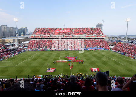 Fans sing the Canadian National anthem before the match between Toronto FC and Houston Dynamo at BMO Field in Toronto, Canada on May 10, 2015. Stock Photo