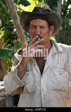 Weathered farmer smoking a cigarette, Valle de los Ingenios (Valley of the Sugar Mills), Trinidad, Cuba Stock Photo