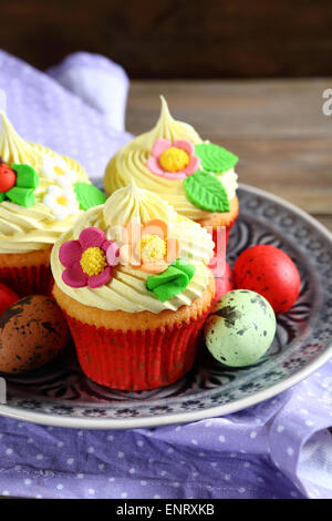 Three cupcakes with eggs on a plate, easter Stock Photo