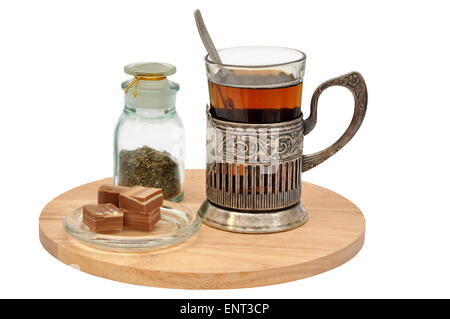 Tea set with vintage glass-holder also known as Russian podstakannik useful in travel by train. Stock Photo