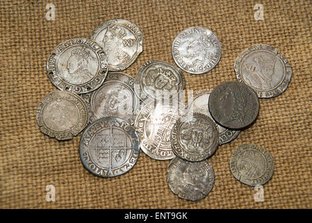 A lot of old England  silver coins with portraits of kings on the old cloth Stock Photo