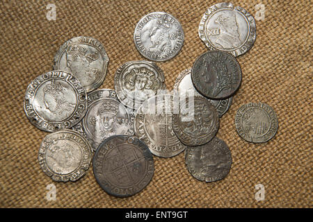 A lot of old England  silver coins with portraits of kings on the old cloth Stock Photo