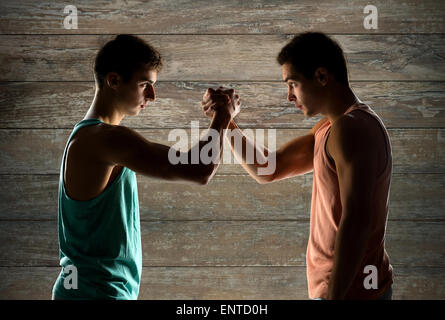 two young men arm wrestling Stock Photo