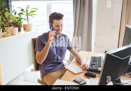 happy creative male worker calling on smarphone Stock Photo