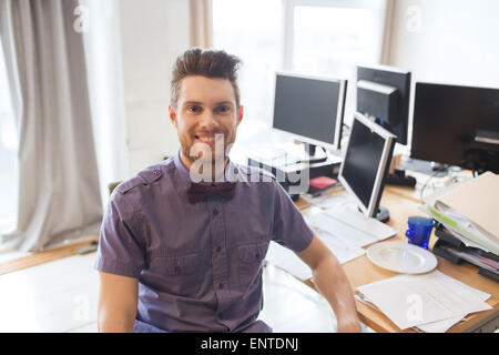 happy creative male office worker with computers Stock Photo