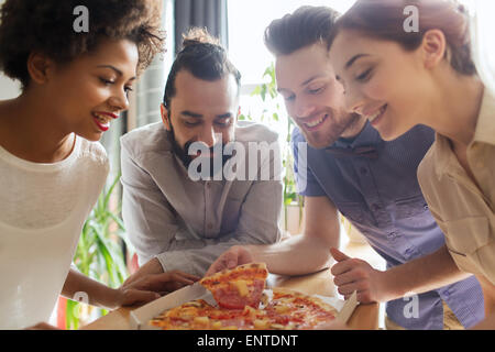 happy business team eating pizza in office Stock Photo
