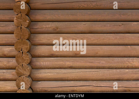 timbered wooden wall made from logs as background Stock Photo