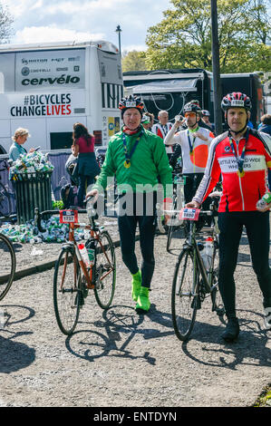 2015 Tour de Yorkshire, Roundhay Park, Leeds, West Yorkshire, two men pushing bike after race with medials around their necks Stock Photo