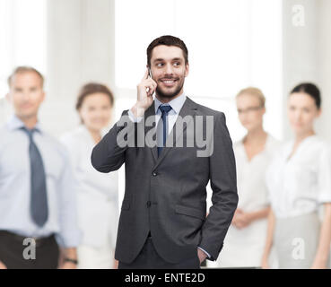 young smiling businessman with smartphone Stock Photo