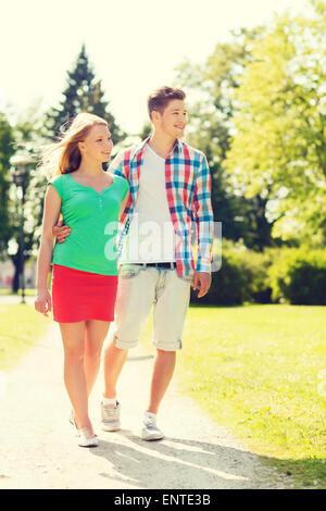smiling couple walking in park Stock Photo