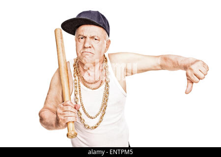 Violent senior in hip-hop clothes holding a baseball bat and giving a thumb down isolated on white background Stock Photo