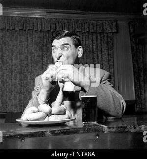 Sausage eating champion: Joe Steele of Bedlington Northumberland champion raw sausage eating champion. Circa 1965. Stock Photo