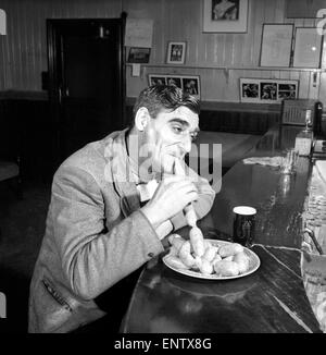 Sausage eating champion: Joe Steele of Bedlington Northumberland champion raw sausage eating champion. Circa 1965. Stock Photo