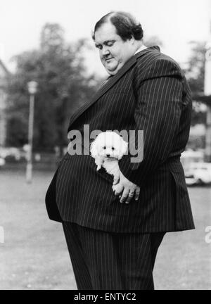 28 stone Colin Taylor and his poodle Tiny Tina in his pocket, go for a walk in Streatham, London. 7th June 1978. Stock Photo