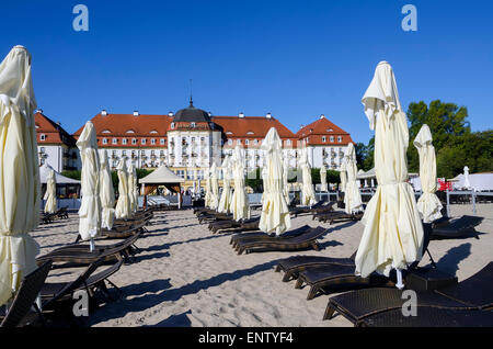 Beach Umbrellas and Sofitel Grand Hotel at Baltic Sea tourist beach destination Sopot Poland Northern Europe Stock Photo