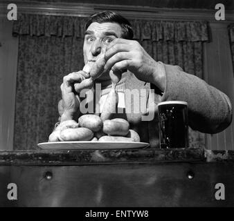 Sausage eating champion: Joe Steele of Bedlington Northumberland champion raw sausage eating champion. Circa 1965. Stock Photo