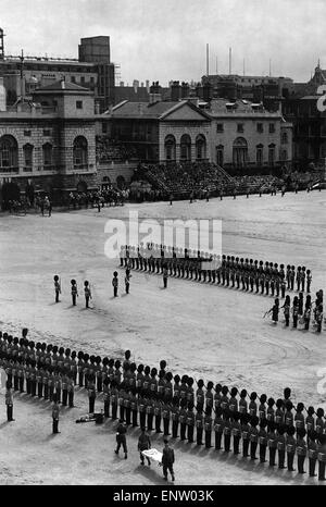 Army: Soldier of thA soldier is stretchered off the parade ground during the Trooping of the Colour ceremony after fainting. 29th May 1951 Stock Photo