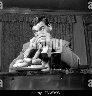 Sausage eating champion: Joe Steele of Bedlington Northumberland champion raw sausage eating champion. Circa 1965. Stock Photo