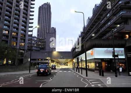 A view of the Barbican residential towers above a lit up Beech Street underpass tunnel with traffic Central London KATHY DEWITT Stock Photo