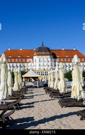 Beach Umbrellas and Sofitel Grand Hotel at Baltic Sea tourist beach destination Sopot Poland Northern Europe Stock Photo