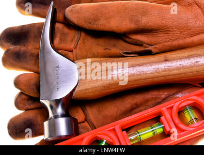 Closeup of new construction framing hammer and bubble level on heavy leather work gloves Made In America Stock Photo