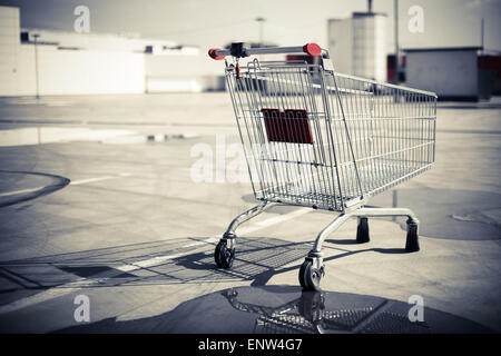 Color image of an abandoned shopping trolley in a parking lot. Stock Photo