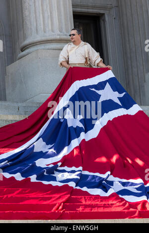 Civil war re-enactors position a gigantic Confederate flag on the steps of the South Carolina State Capitol building May 2, 2015 in Columbia, SC. Confederate Memorial Day is an official state holiday in South Carolina and honors those that served during the Civil War. Stock Photo