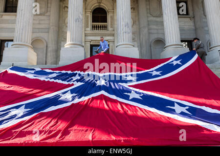 Civil war re-enactors position a gigantic Confederate flag on the steps of the South Carolina State Capitol building May 2, 2015 in Columbia, SC. Confederate Memorial Day is an official state holiday in South Carolina and honors those that served during the Civil War. Stock Photo