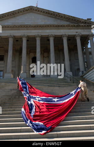 Civil war re-enactors position a gigantic Confederate flag on the steps of the South Carolina State Capitol building May 2, 2015 in Columbia, SC. Confederate Memorial Day is an official state holiday in South Carolina and honors those that served during the Civil War. Stock Photo