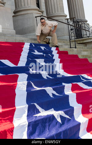 Civil war re-enactors position a gigantic Confederate flag on the steps of the South Carolina State Capitol building May 2, 2015 in Columbia, SC. Confederate Memorial Day is an official state holiday in South Carolina and honors those that served during the Civil War. Stock Photo