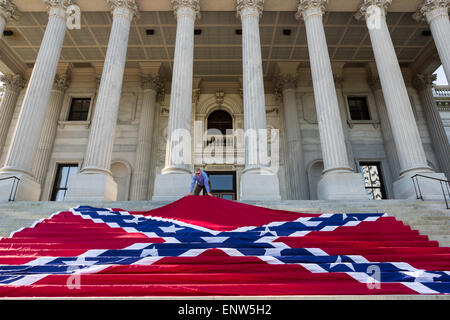 Civil war re-enactors position a gigantic Confederate flag on the steps of the South Carolina State Capitol building May 2, 2015 in Columbia, SC. Confederate Memorial Day is an official state holiday in South Carolina and honors those that served during the Civil War. Stock Photo