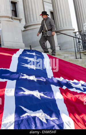 Civil war re-enactors position a gigantic Confederate flag on the steps of the South Carolina State Capitol building May 2, 2015 in Columbia, SC. Confederate Memorial Day is an official state holiday in South Carolina and honors those that served during the Civil War. Stock Photo