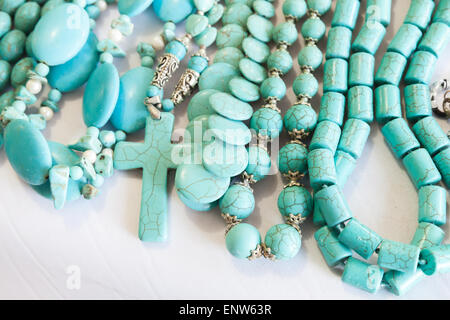 Beads of blue turquoise stone lie on the counter of souvenir shop on the beach in Dominican republic Stock Photo